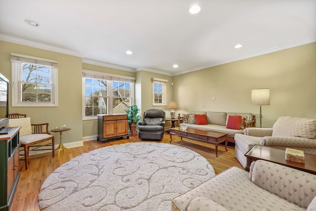 living room with crown molding and light hardwood / wood-style flooring