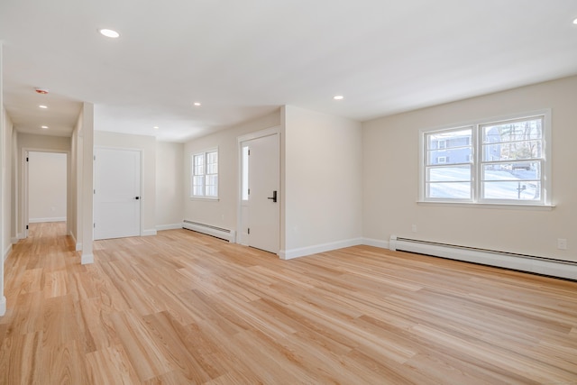 foyer entrance featuring light wood-type flooring and a baseboard heating unit