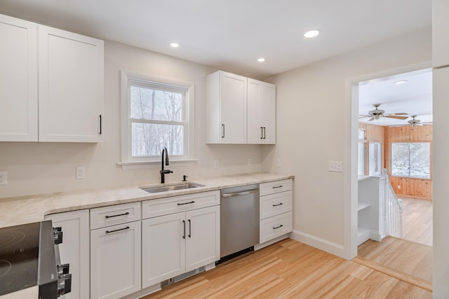 kitchen with dishwasher, sink, white cabinets, a healthy amount of sunlight, and light hardwood / wood-style flooring