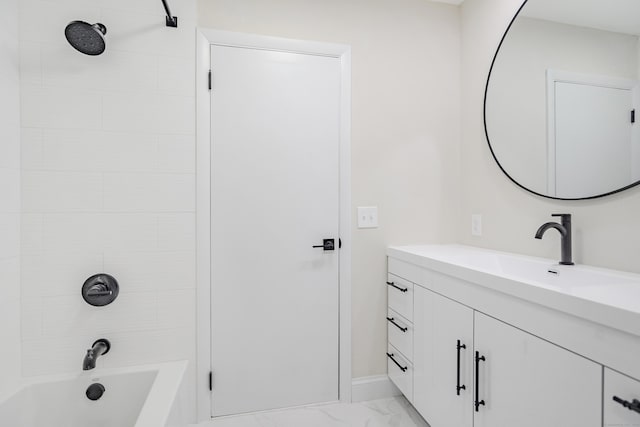 bathroom with vanity and tiled shower / bath combo