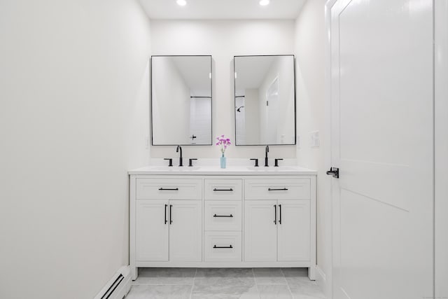 bathroom with vanity and a baseboard heating unit