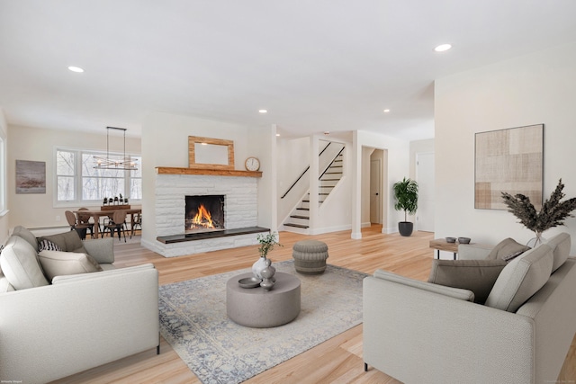 living room with a fireplace and light hardwood / wood-style flooring