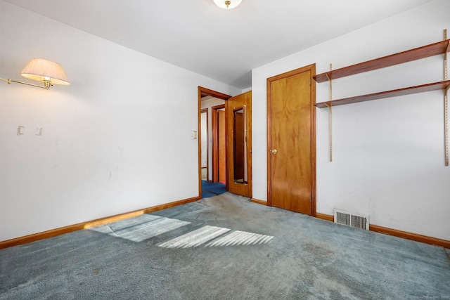 unfurnished bedroom with light colored carpet and a closet