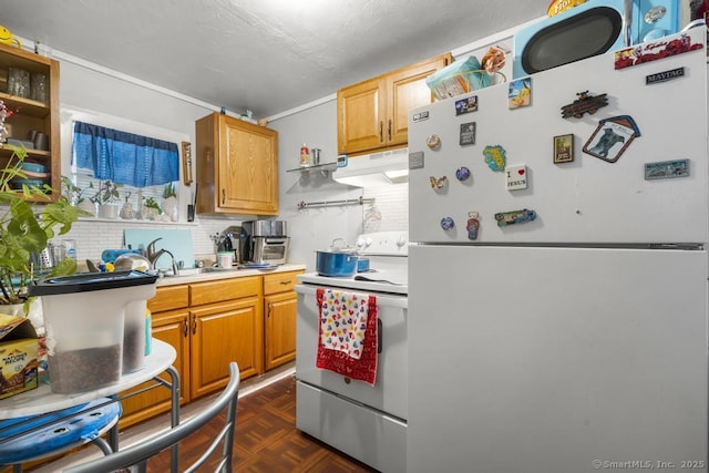 kitchen featuring dark parquet flooring, sink, backsplash, and white appliances