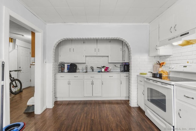 kitchen with dark hardwood / wood-style floors, white cabinets, backsplash, white electric range oven, and crown molding