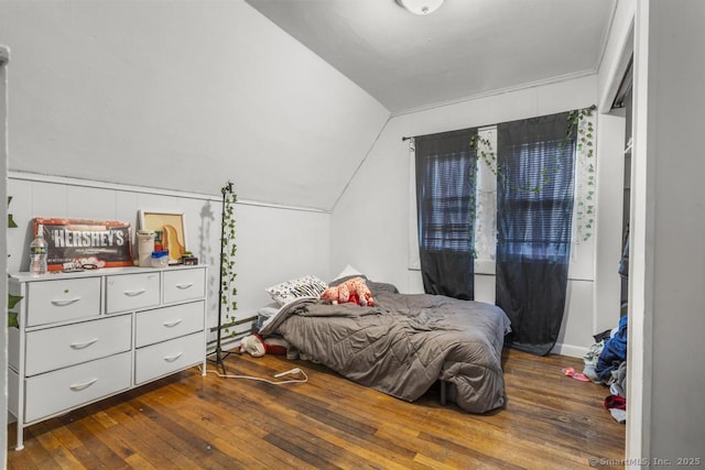 bedroom featuring lofted ceiling, dark wood-type flooring, and baseboard heating