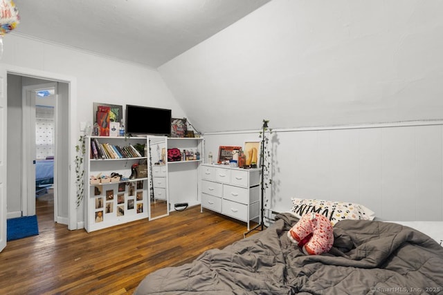 bedroom with dark wood-type flooring and lofted ceiling