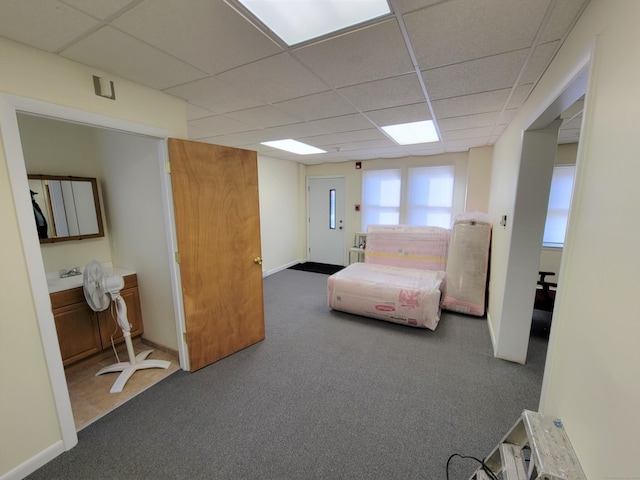 carpeted bedroom with a drop ceiling