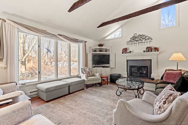 living room featuring beamed ceiling, ceiling fan, plenty of natural light, and a baseboard heating unit