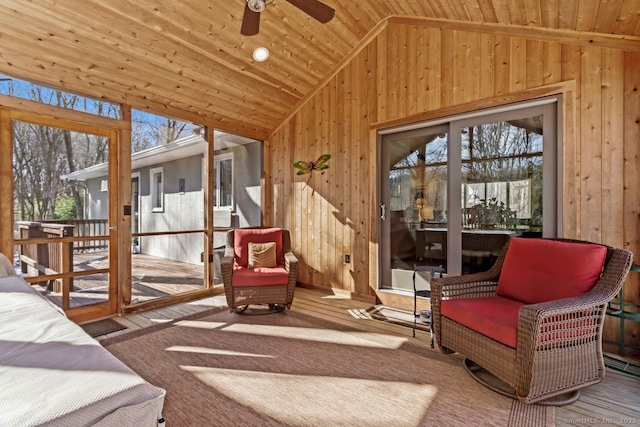 sunroom with vaulted ceiling, ceiling fan, and wood ceiling