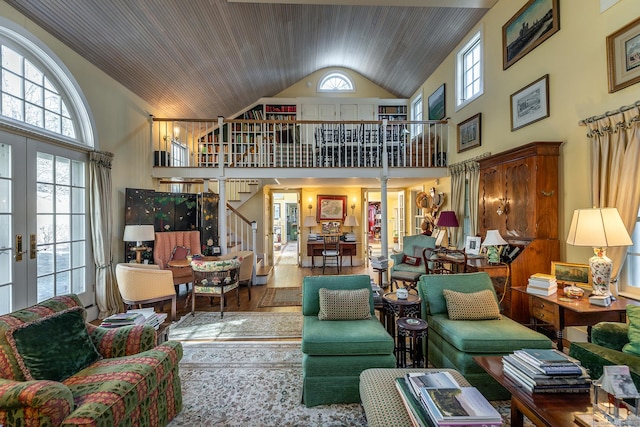 living area featuring stairway, wood finished floors, high vaulted ceiling, french doors, and wooden ceiling