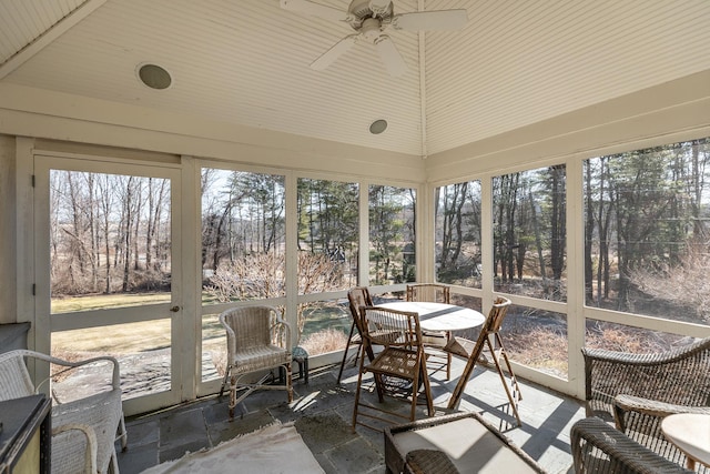 sunroom / solarium featuring ceiling fan