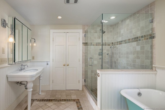 bathroom featuring independent shower and bath and tile patterned flooring