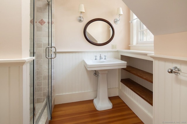 bathroom featuring hardwood / wood-style flooring and a shower with door