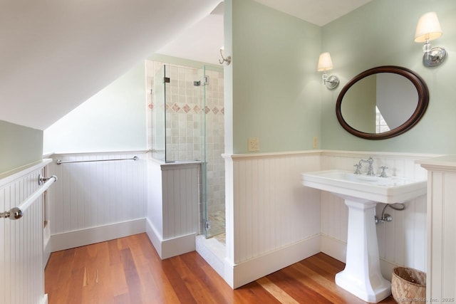 bathroom with hardwood / wood-style flooring, lofted ceiling, and an enclosed shower