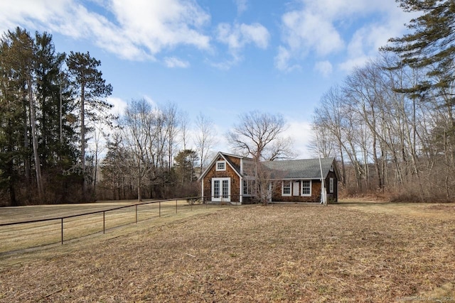 view of front of property featuring french doors and a front lawn