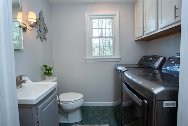 washroom featuring washing machine and clothes dryer and sink