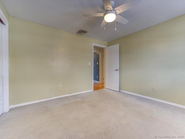 spare room with light carpet and ceiling fan