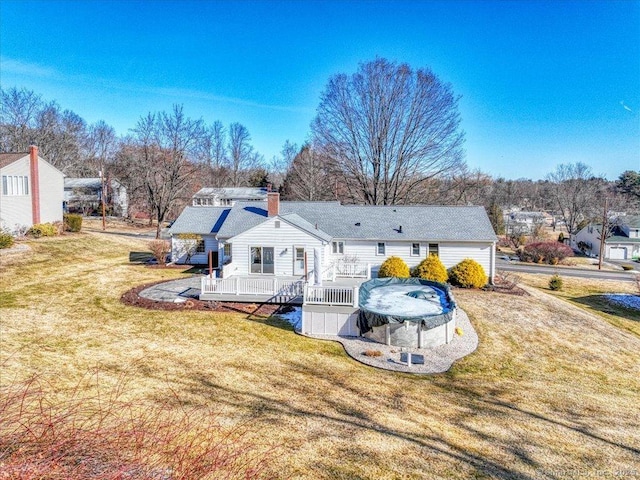 back of house with a wooden deck and a yard