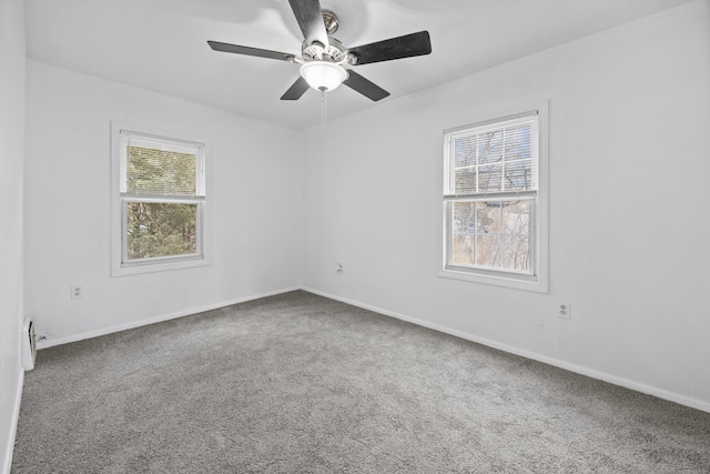 carpeted spare room with ceiling fan