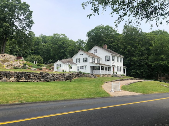 view of front of property with a front lawn and a porch