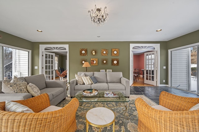 living room with a wealth of natural light and a chandelier