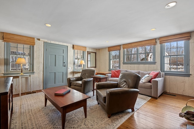 living room featuring wooden walls and light wood-type flooring