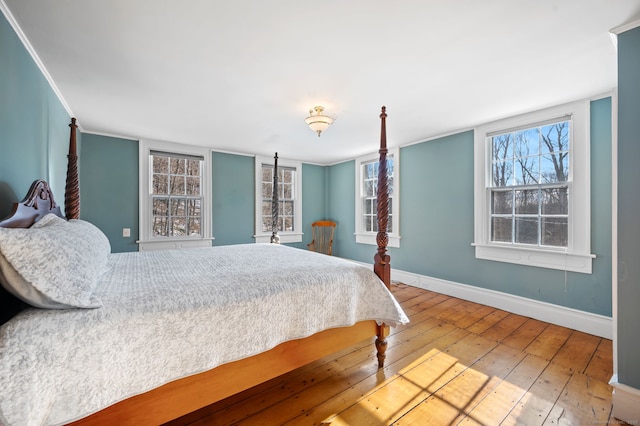 bedroom featuring ornamental molding and hardwood / wood-style floors