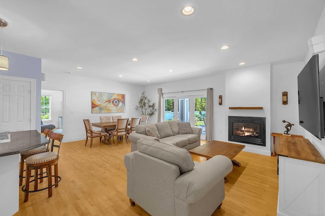 155 W Rd, East Haddam, CT 06420 - living area with healthy amount of natural light, light wood finished floors, a glass covered fireplace, and recessed lighting