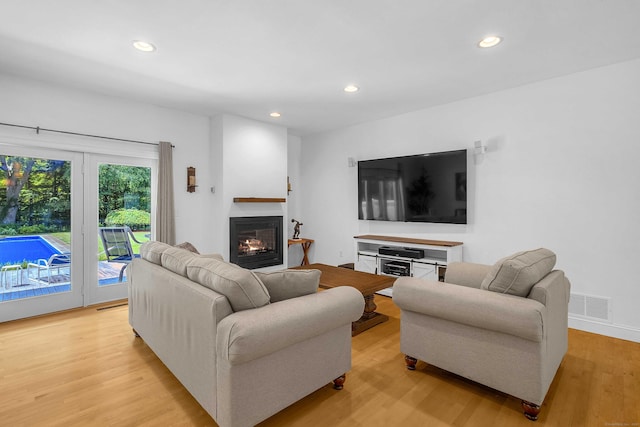 155 W Rd, East Haddam, CT 06420 - living room with light wood finished floors, a glass covered fireplace, and recessed lighting