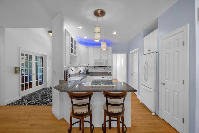 155 W Rd, East Haddam, CT 06420 - kitchen featuring a peninsula, white appliances, white cabinetry, light wood-style floors, and recessed lighting