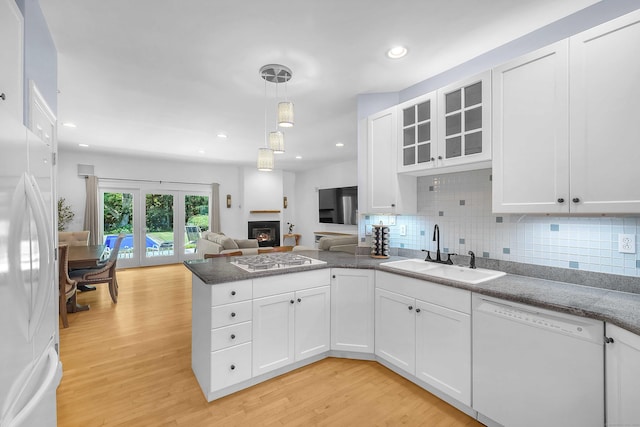 155 W Rd, East Haddam, CT 06420 - kitchen with a peninsula, white appliances, open floor plan, light wood finished floors, and white cabinets