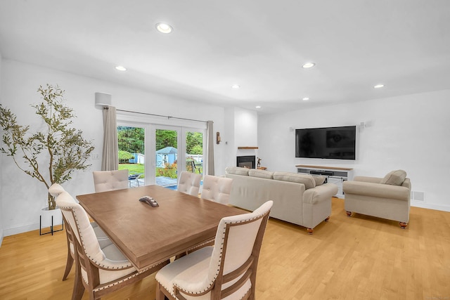 155 W Rd, East Haddam, CT 06420 - dining area featuring light wood-style floors, recessed lighting, a glass covered fireplace, and french doors