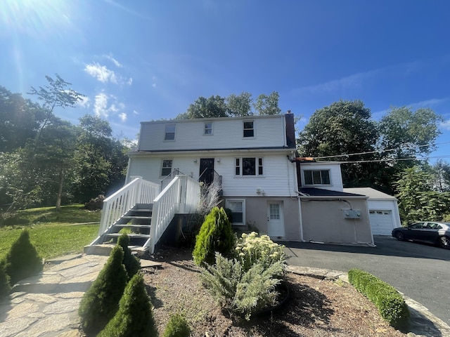 view of front of property with a garage and an outdoor structure