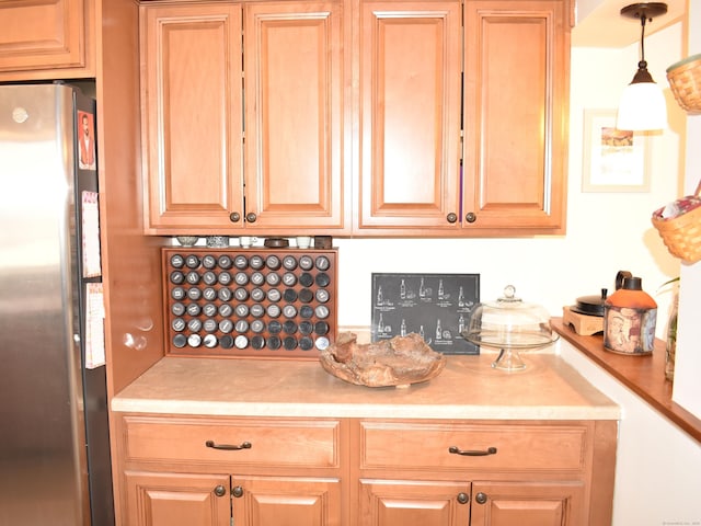 kitchen featuring pendant lighting and stainless steel fridge