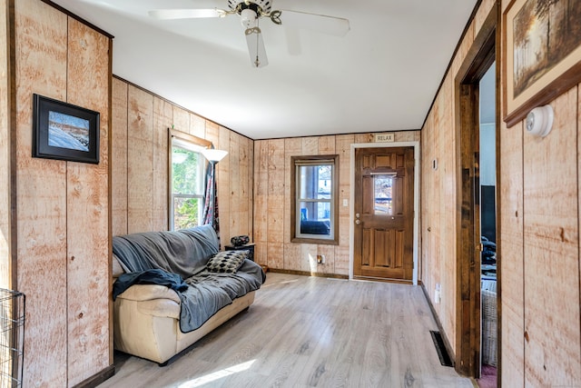 foyer with ceiling fan and light wood-type flooring