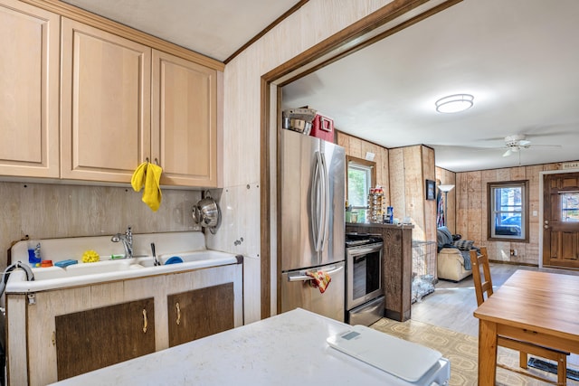 kitchen with stainless steel appliances, sink, a wealth of natural light, and light brown cabinets