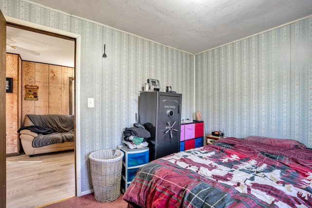 bedroom featuring hardwood / wood-style floors and a textured ceiling