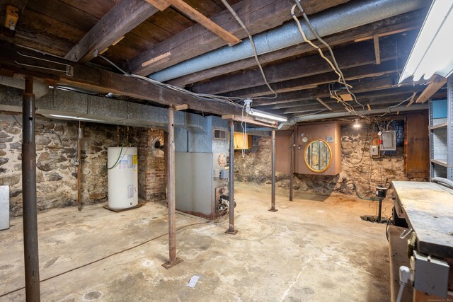 basement with electric panel and water heater