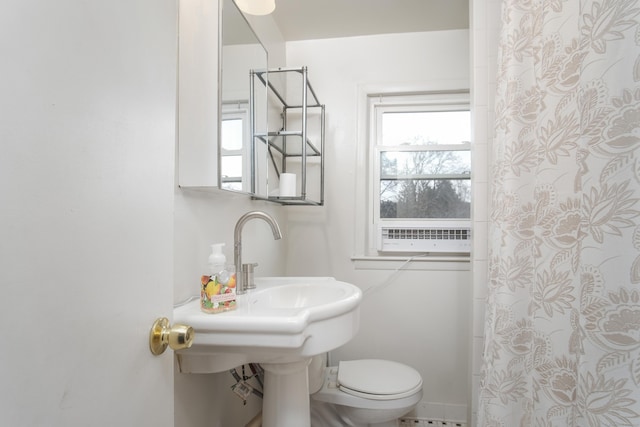 bathroom featuring walk in shower and toilet