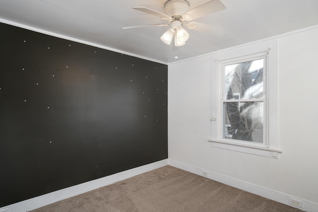 carpeted empty room featuring a wealth of natural light and ceiling fan