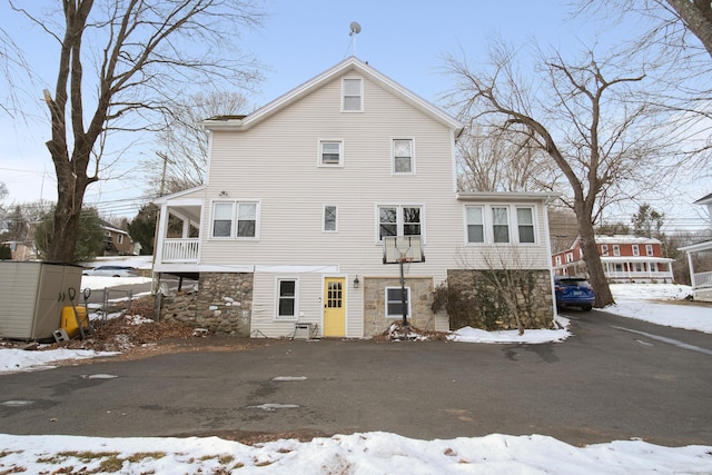 view of snow covered rear of property