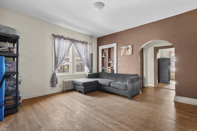 living room with radiator and hardwood / wood-style floors