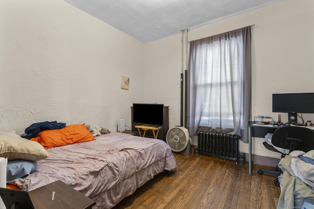 bedroom featuring dark hardwood / wood-style floors and radiator