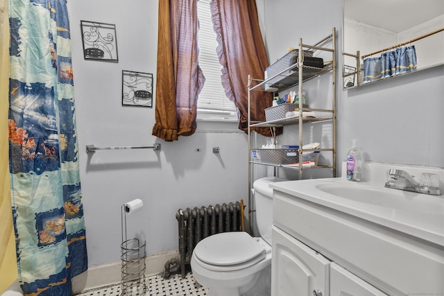 bathroom with vanity, radiator, and toilet