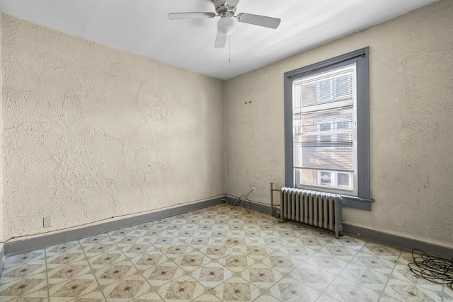 empty room with radiator and ceiling fan