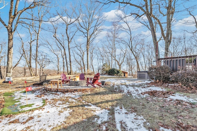 snowy yard with a fire pit