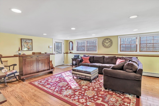 living room with a baseboard radiator and light hardwood / wood-style floors