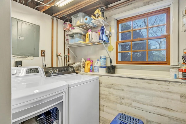 laundry room featuring electric panel and washer and clothes dryer