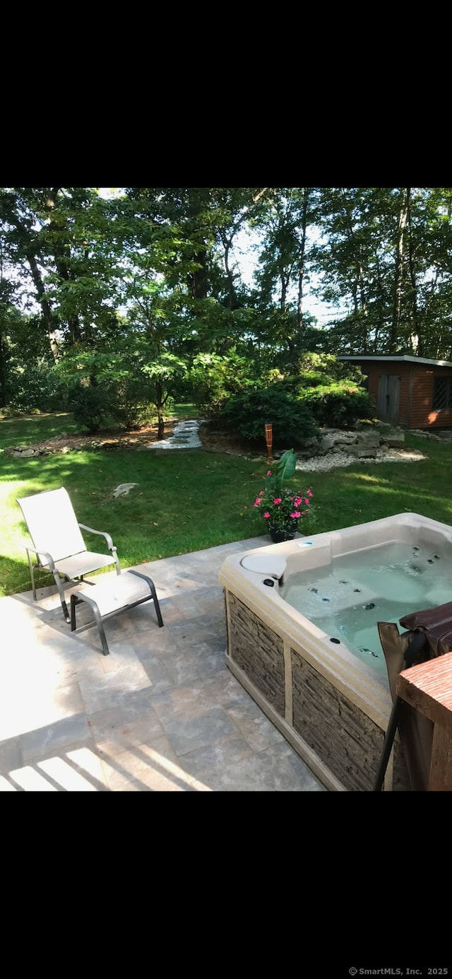 view of patio with an outdoor hot tub